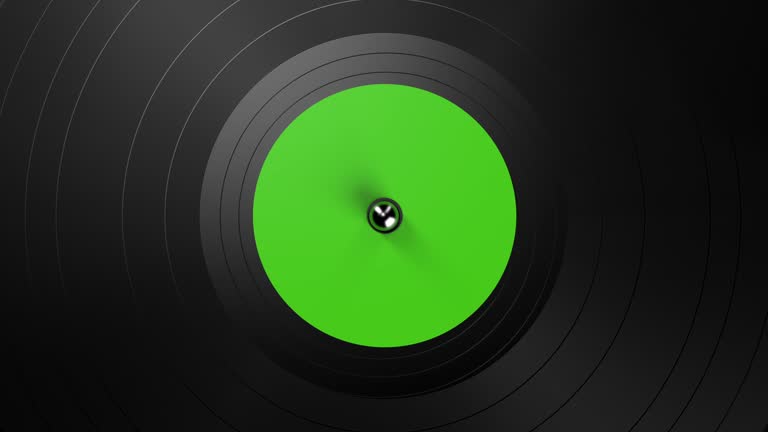 Black vinyl record on a turntable. A black vinyl background with a green sticker in the center, rotating in a circle. Looped 3d animation