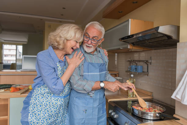 istock Senior Couple is Preparing Delicious Dinner in the Kitchen. 1257537923