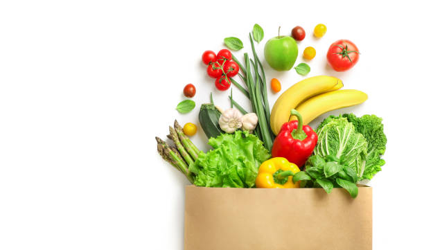 Fresh food delivery service Paper bag full of different healthy food isolated on white background. Top view. fruit stock pictures, royalty-free photos & images