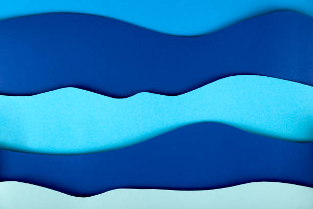 istock Blue background paper art sea waves with copy space. 1257538697