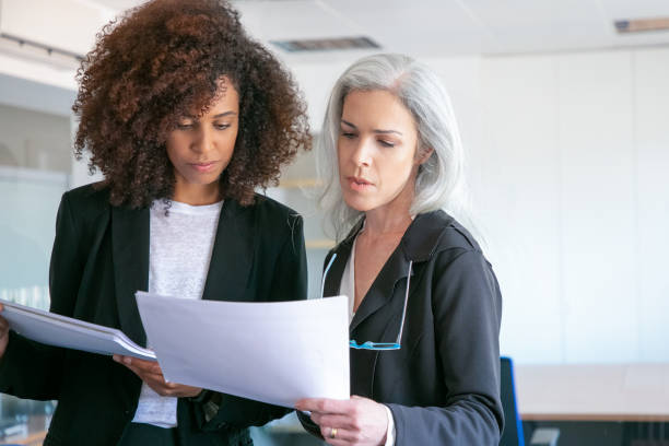 istock Professional female partners reading document in office room 1257539102