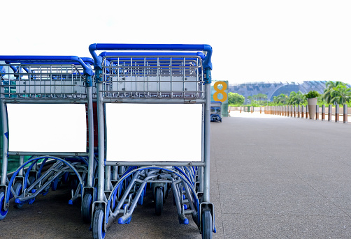 Visual of parked airport luggage trolleys. Advertising display areas blanked out for easy ad placements, for advertising OOH mockup. Presentation display purpose only.