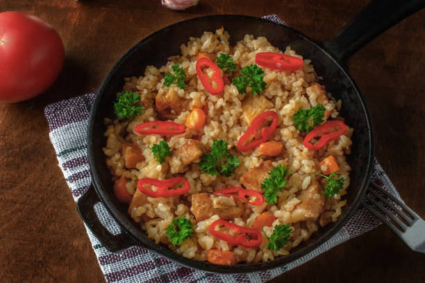 istock Rice with meat, vegetables and parsley in a serving pan 1257543233