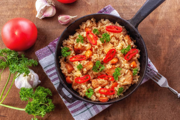 istock Rice with meat, vegetables and parsley in a serving pan 1257543259