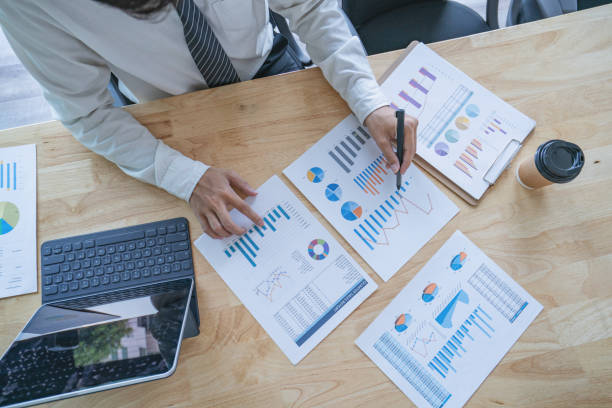 istock businessman working plan the business and analysis many chart graph, top view. 1257543983