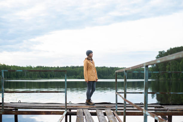 istock Female traveller looking at lake view 1257546125