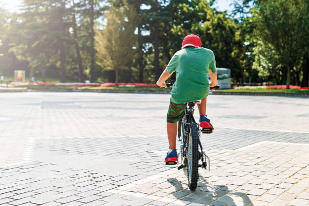 istock Cute little boy riding bicycle 1257546678