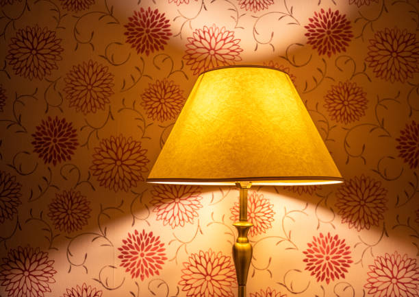 Red and yellow light with lamp shade Lamp and shade colourfuly lit with a patterned wallpaper background lamp shade stock pictures, royalty-free photos & images