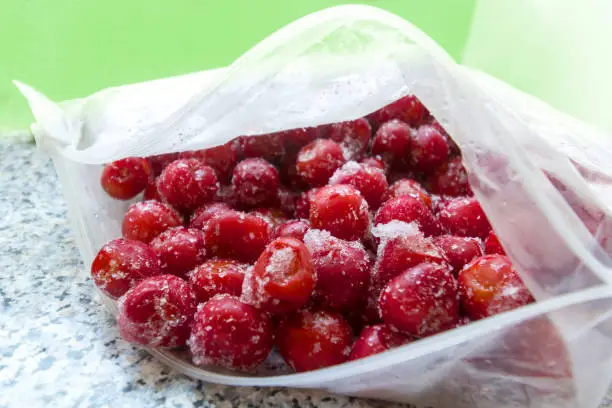 Photo of Frozen cherries in an open plastic bag