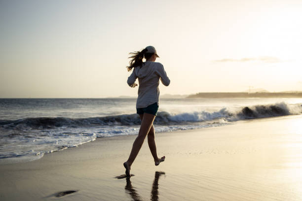 istock Young woman having fun at the ocean beach 1257548007