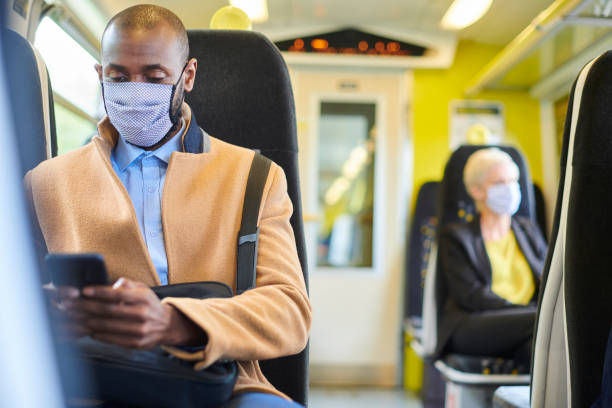 istock train passenger with homemade mask texting 1257549263