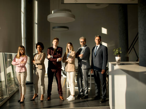 istock Multiethnic corporate staff standing in row and looking in the camera 1257550306