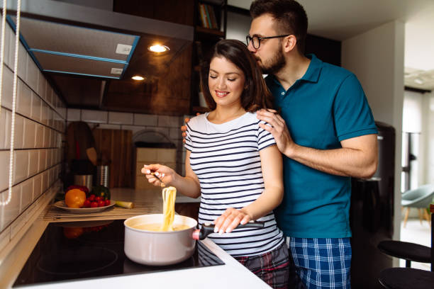 istock Young couple cooking together at home 1257551507