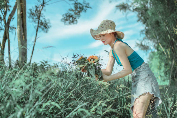 Natural beauty girl with bouquet of flowers outdoor in freedom enjoyment concept