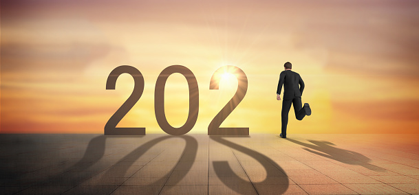 Happy New year 2021 trend concept.Graduate man run to number 2021 in the new year of hope , beginning, new job start new life with 2021 sunrise backgroud