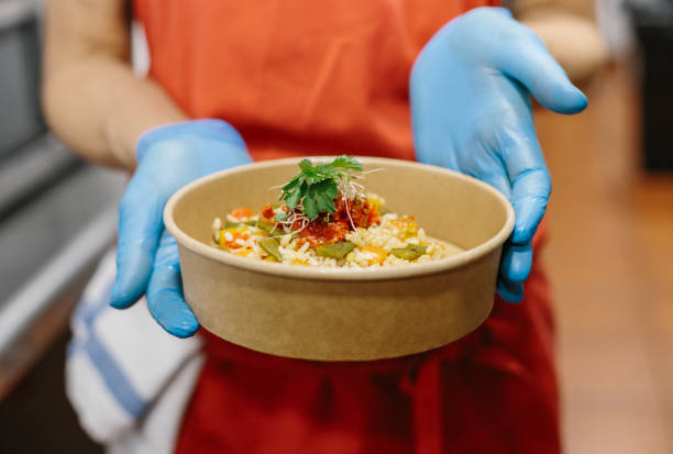 istock A cook presents her gourmet rice salad in a compostable take-away container 1257555816
