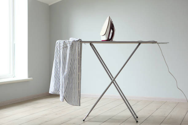 istock Iron and ironing board in a bright room. Iron clothes. 1257556888