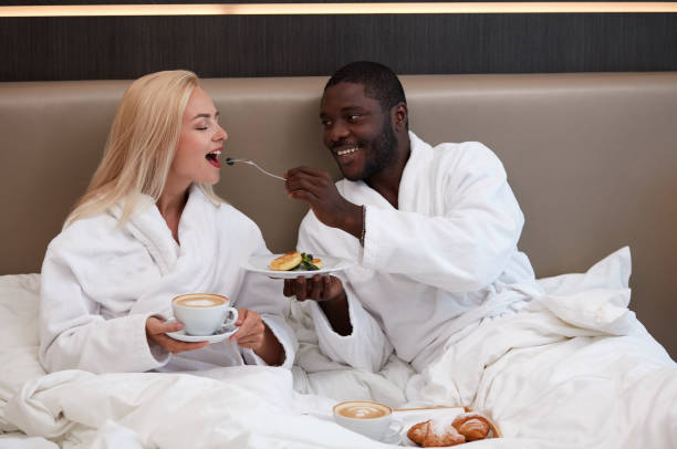 istock adorable multiethnic couple have breakfast in hotel 1257557304
