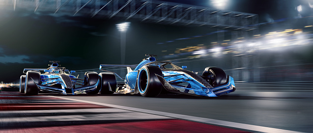 Two blue toned racing generic racing cars racing at high speed close to each other on a generic racetrack near to a spectators stand, during a night race. With motion blur.