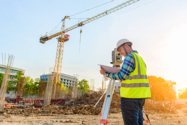 istock Surveying engineers are working together using theodolite on the construction site. 1257559284