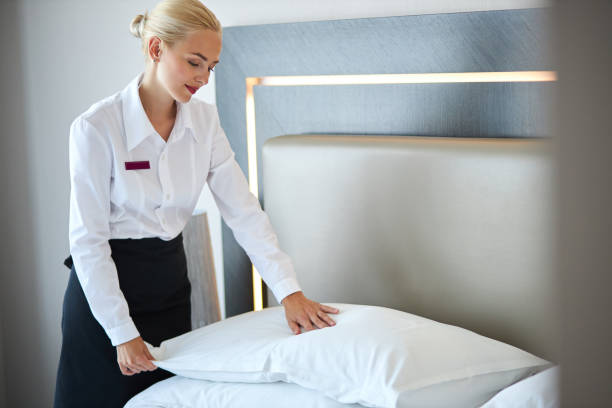 istock nice maid prepares a bed for guests 1257559452
