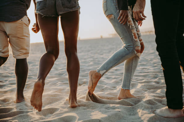 istock Friends dancing barefoot on the beach 1257559472