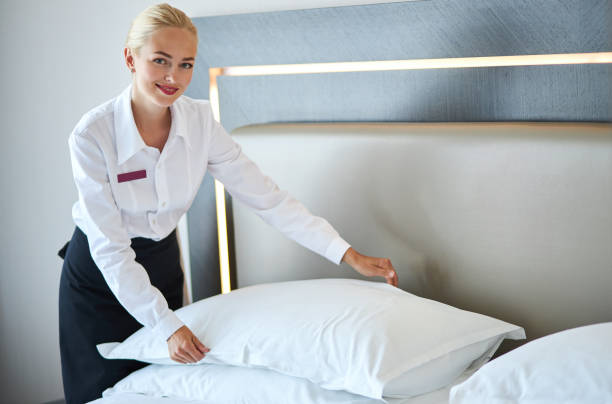 istock beautiful housemaid changes the pillowcase on the bed 1257559504
