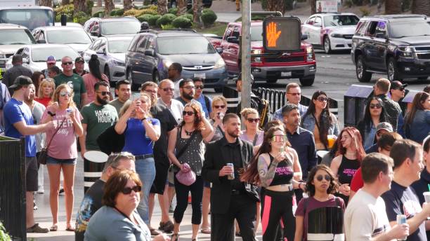 people on pedestrian walkway. multicultural men and women walking on city promenade. crowd of citizens on sidewalk. diversity of multiracial faces in metropolis - downtown las vegas fremont street experience nevada las vegas metropolitan area imagens e fotografias de stock