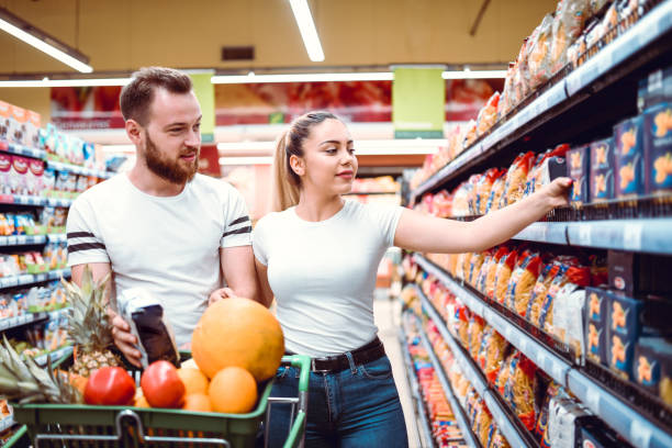 istock Cute Couple Shopping Different Groceries For Home 1257562162