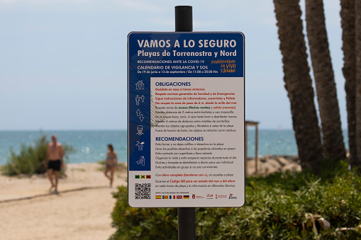 Torrenostra, Castellón, Spain - July 19, 2020: Informational sign on the beach to explain the obligations and regulations in the prevention of COVID-19.
