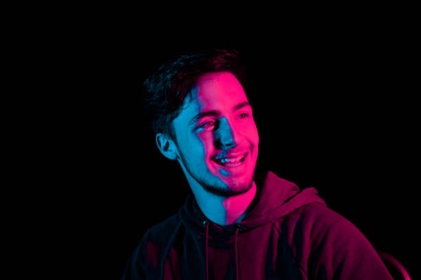 istock Laughing Young Man Illuminated LED Night Portrait Series 1257563229