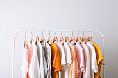 istock fashion clothes on a rack in a light background indoors. place for text 1257563298