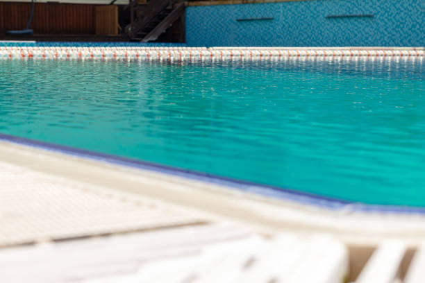 istock Refreshing swimming pool sunny day, with blue water relax vacation concept 1257563516