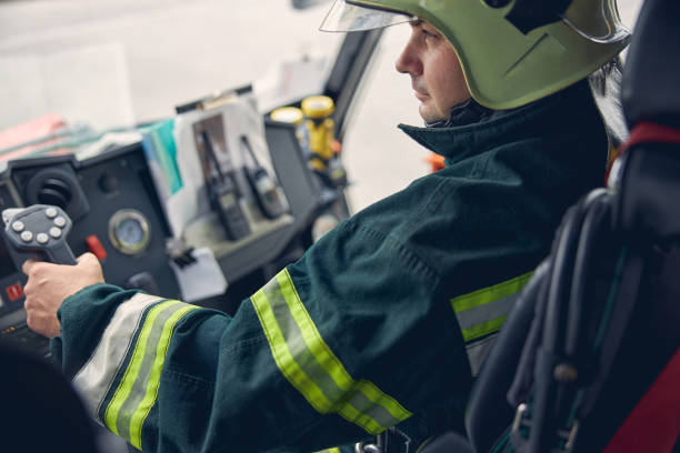 istock Mature man looking ahead while sitting in the fire machine 1257564987