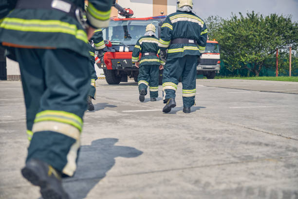 istock Three confident strong men running to modern truck at fire station 1257565034