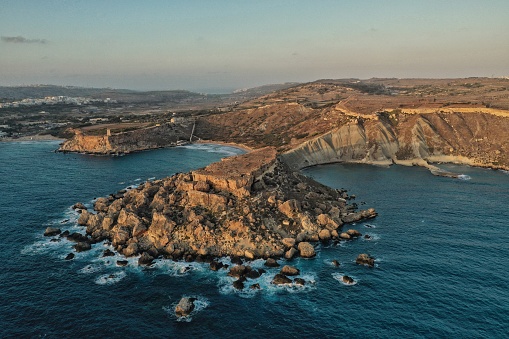 An aerial photo taken using a Drone in Malta of Golden Bay & Ghajn Tuffieha Beach at Sunset,  Toning has been applied to this image
