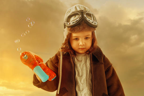 istock Aviator baby girl with bubble toy feeling sad 1257567991