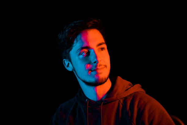 istock Smiling Young Man Illuminated LED Duo Tone Night Portrait Series 1257568281
