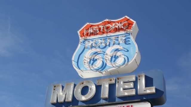 Motel retro sign on historic route 66 famous travel destination, vintage symbol of road trip in USA. Iconic lodging signboard in Arizona desert. Old-fashioned neon signage. Classic tourist landmark