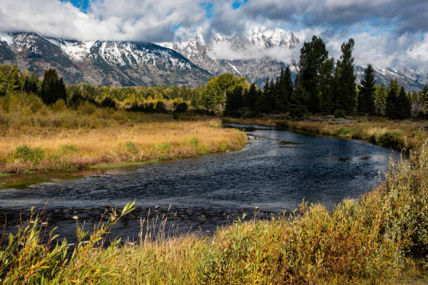 istock Snow-capped mountains and river in the Grand Tetons. 1257568741