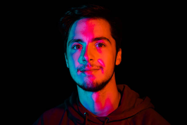istock Iluminated LED Neon Young Man at Night Portrait Series 1257570839