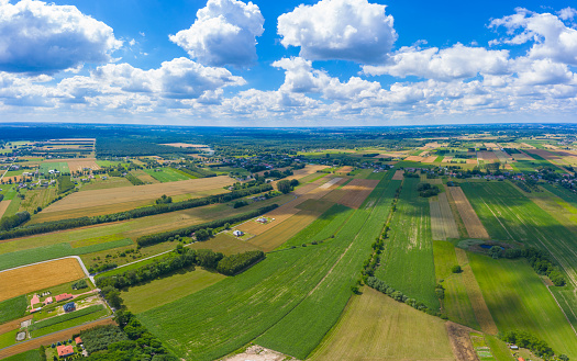 Stunning aerial panorama from a drone of countryside, village, green fields and trees, agriculture concept.