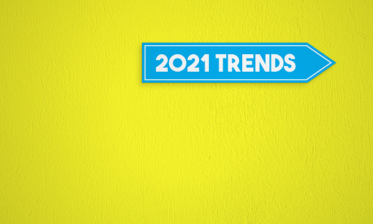 2021 Trends Directional Sign On The Yellow Wall Background. Horizontal composition with copy space.
