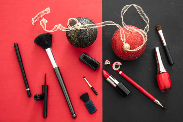 istock Make-up accessories and xmas decoration against red and black background, copy space 1257571583
