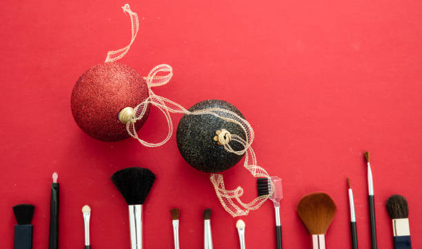 istock Make-up brushes and xmas decoration against red background, copy space 1257571590