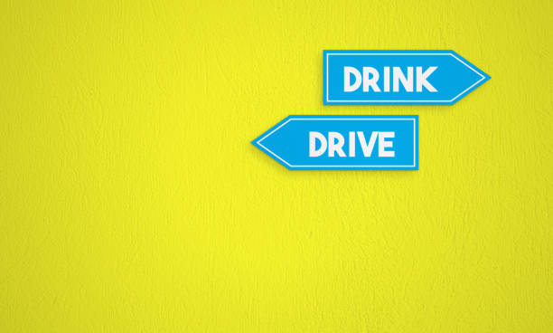 istock Drink And Drive Directional Sign On The Yellow Wall Background 1257572378