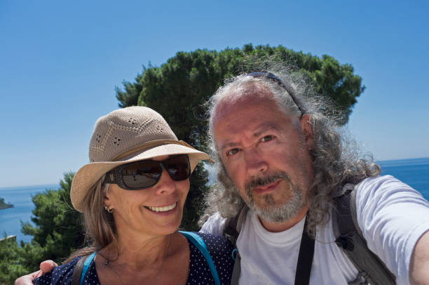 istock traveling senior couple taking selfie 1257572982