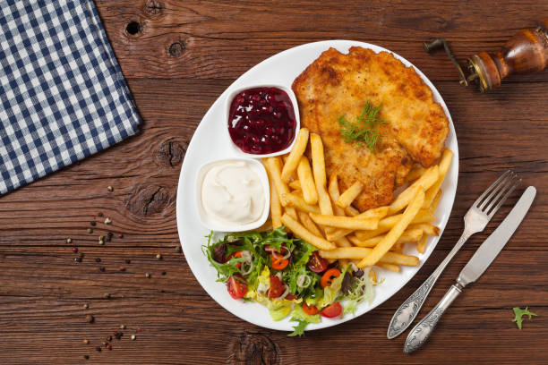 istock Chicken schnitzel, served with fries and salad. 1257576492