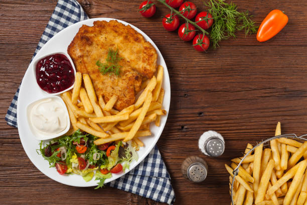 istock Chicken schnitzel, served with fries and salad. 1257576547