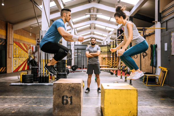 Box Jumping Exercises Young People Doing Crouch-Jumping Exercises On Cross Training sports training drill stock pictures, royalty-free photos & images